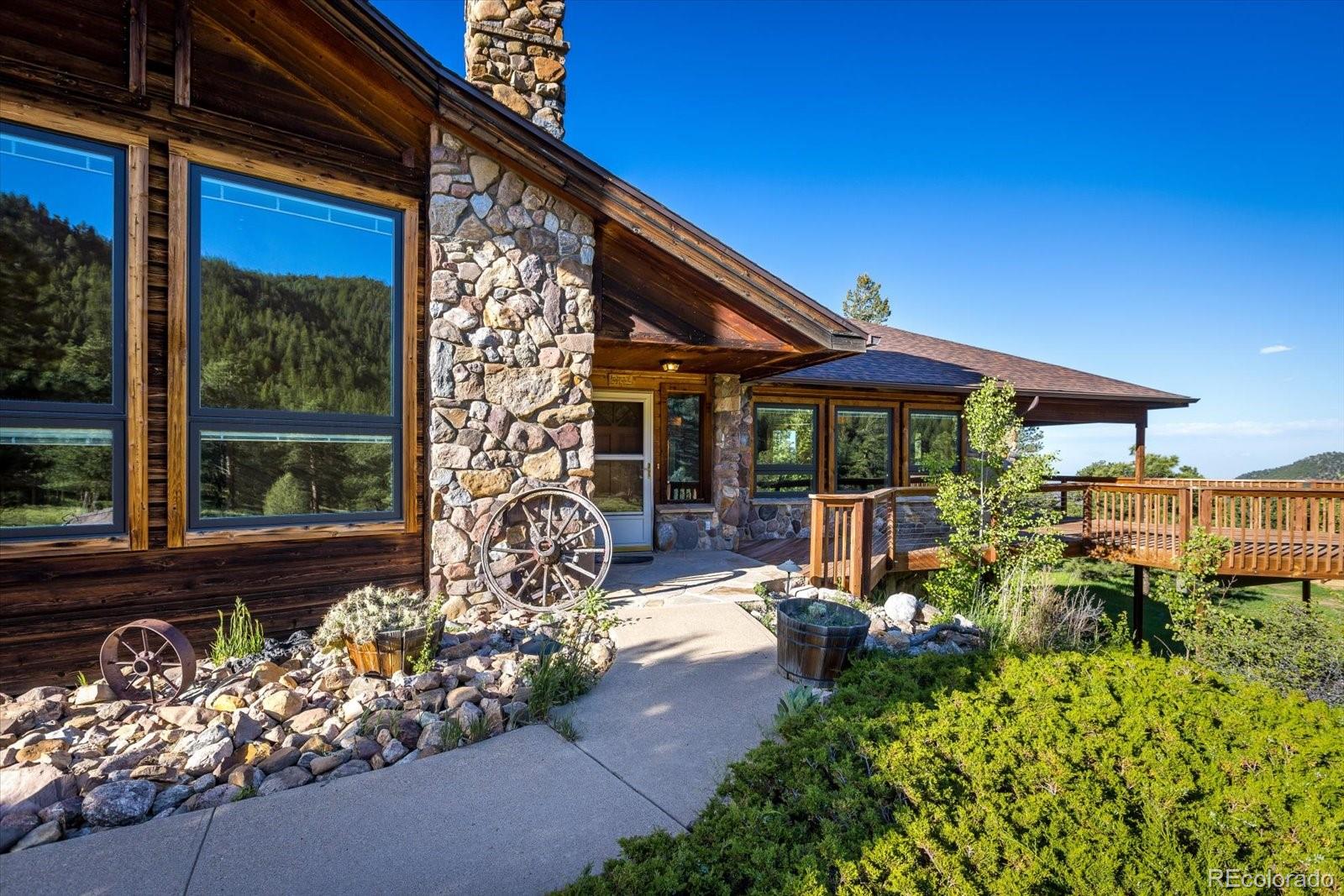 283 Chute Road Golden, CO 80403 - Photo 7 of 40 a view of a house with large windows and flower plants