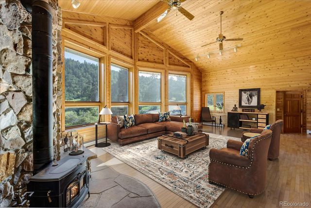 a living room with furniture and a floor to ceiling window