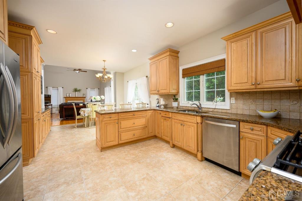 133 Thomas Drive Clark, NJ 07066 - Photo 11 of 30 a large kitchen with stainless steel appliances granite countertop a large counter top a sink a stove a refrigerator and cabinets