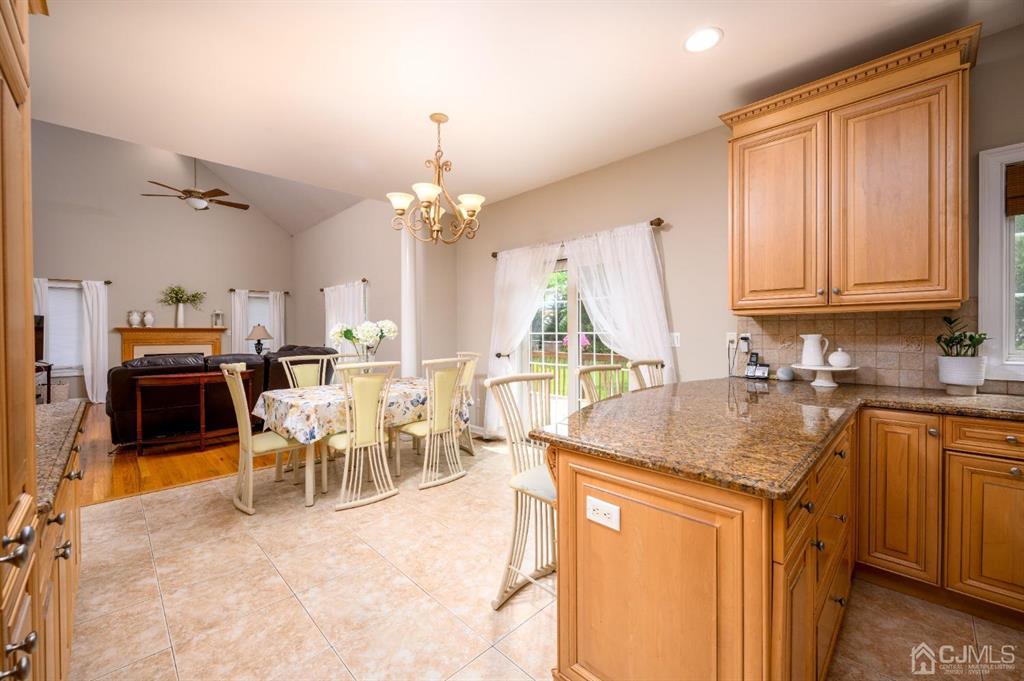 133 Thomas Drive Clark, NJ 07066 - Photo 13 of 30 a very nice looking dining room with a kitchen island furniture and a chandelier