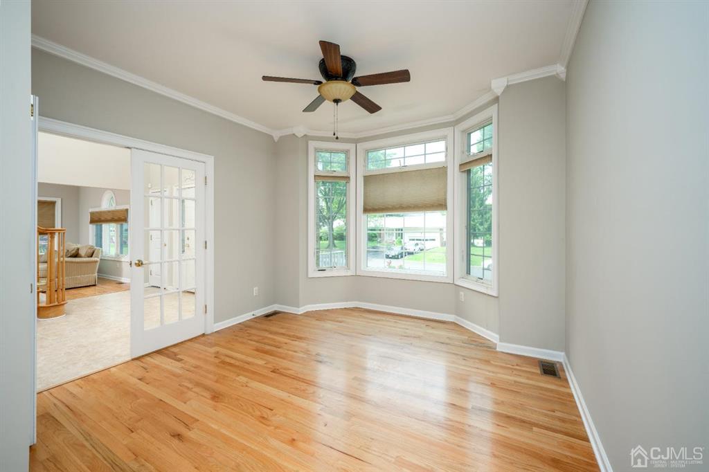 133 Thomas Drive Clark, NJ 07066 - Photo 19 of 30 a view of empty room with wooden floor and fan