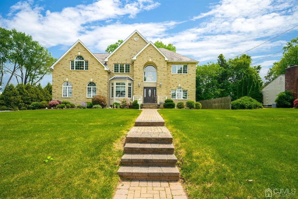 133 Thomas Drive Clark, NJ 07066 - Photo 2 of 30 a front view of a house with a yard