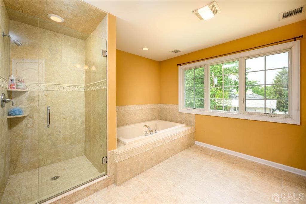 133 Thomas Drive Clark, NJ 07066 - Photo 21 of 30 a bathroom with a bathtub and a shower
