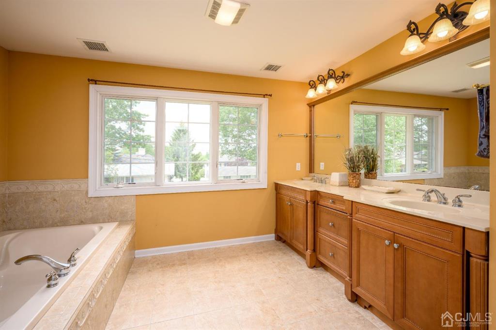 133 Thomas Drive Clark, NJ 07066 - Photo 22 of 30 a bathroom with a granite countertop sink and large window