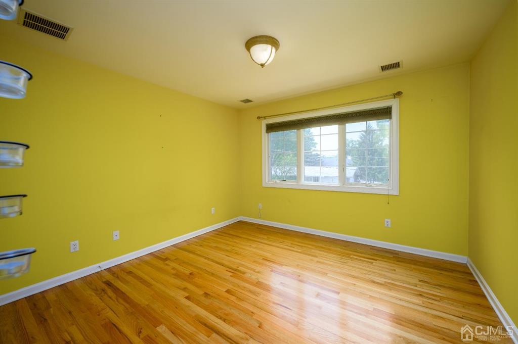 133 Thomas Drive Clark, NJ 07066 - Photo 24 of 30 a view of a room with wooden floor and fan
