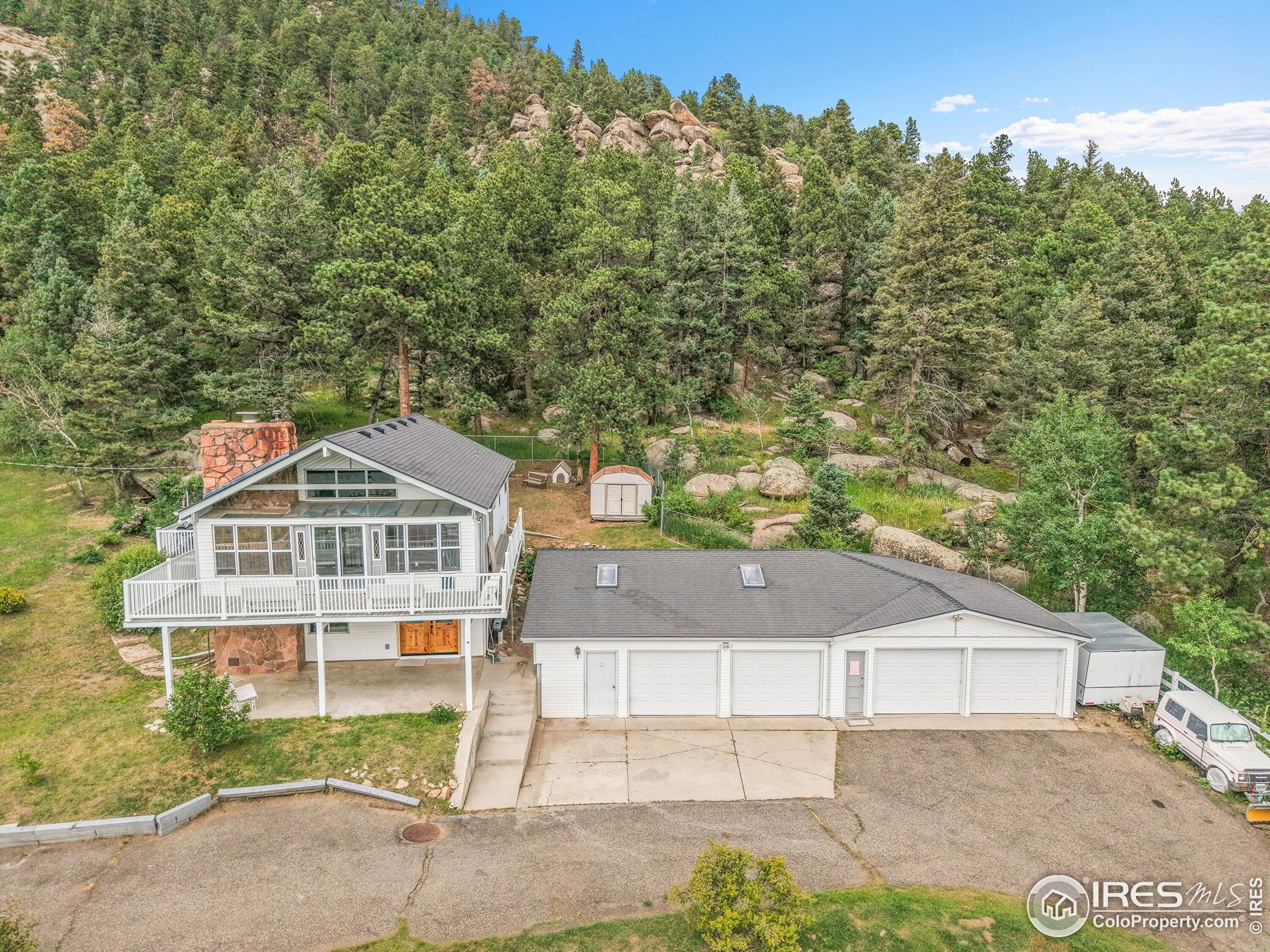 24927 Agate Avenue Conifer, CO 80433 - Photo 1 of 33 a front view of a house with a yard and garage