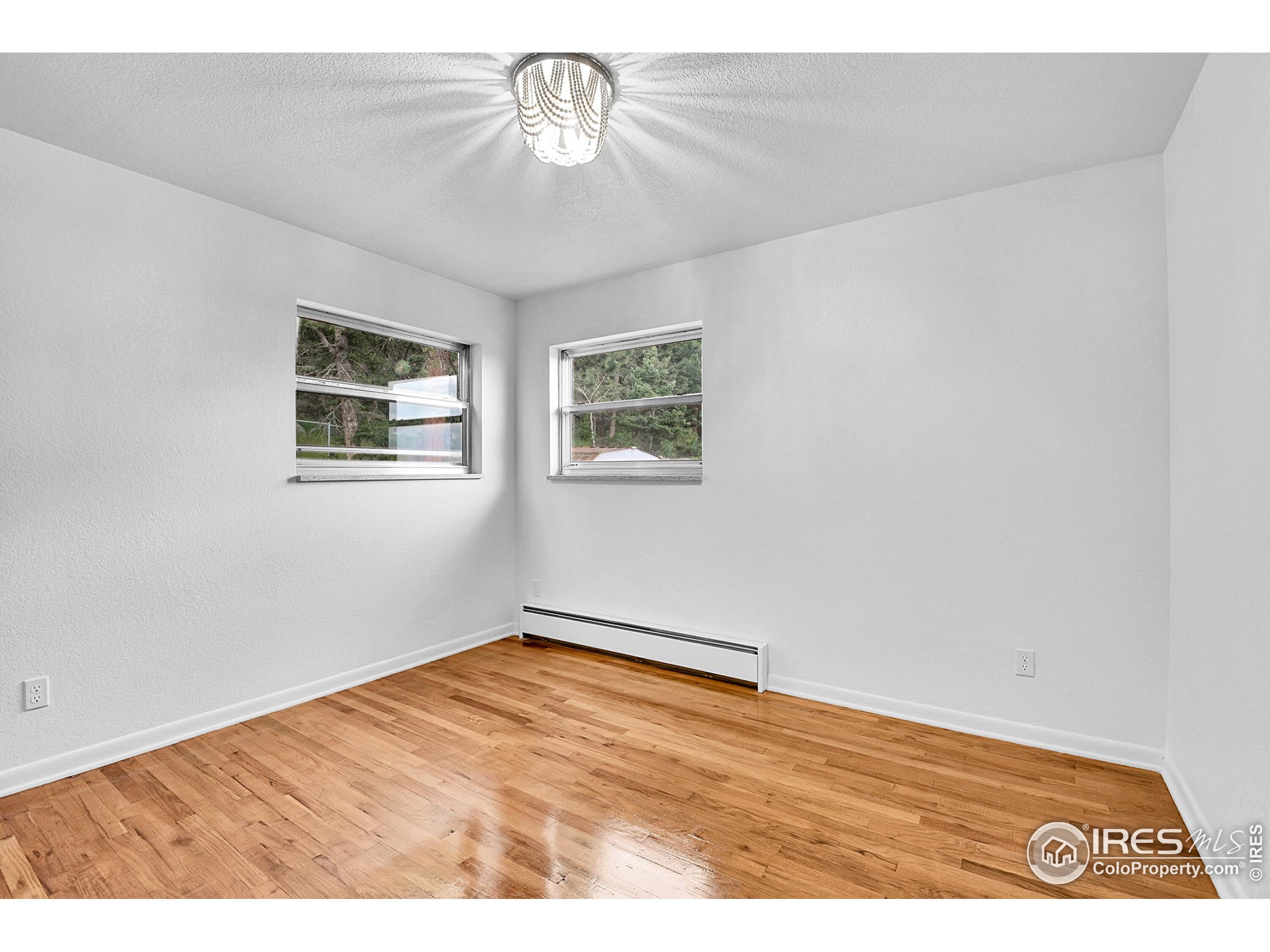 24927 Agate Avenue Conifer, CO 80433 - Photo 14 of 33 a view of empty room with wooden floor