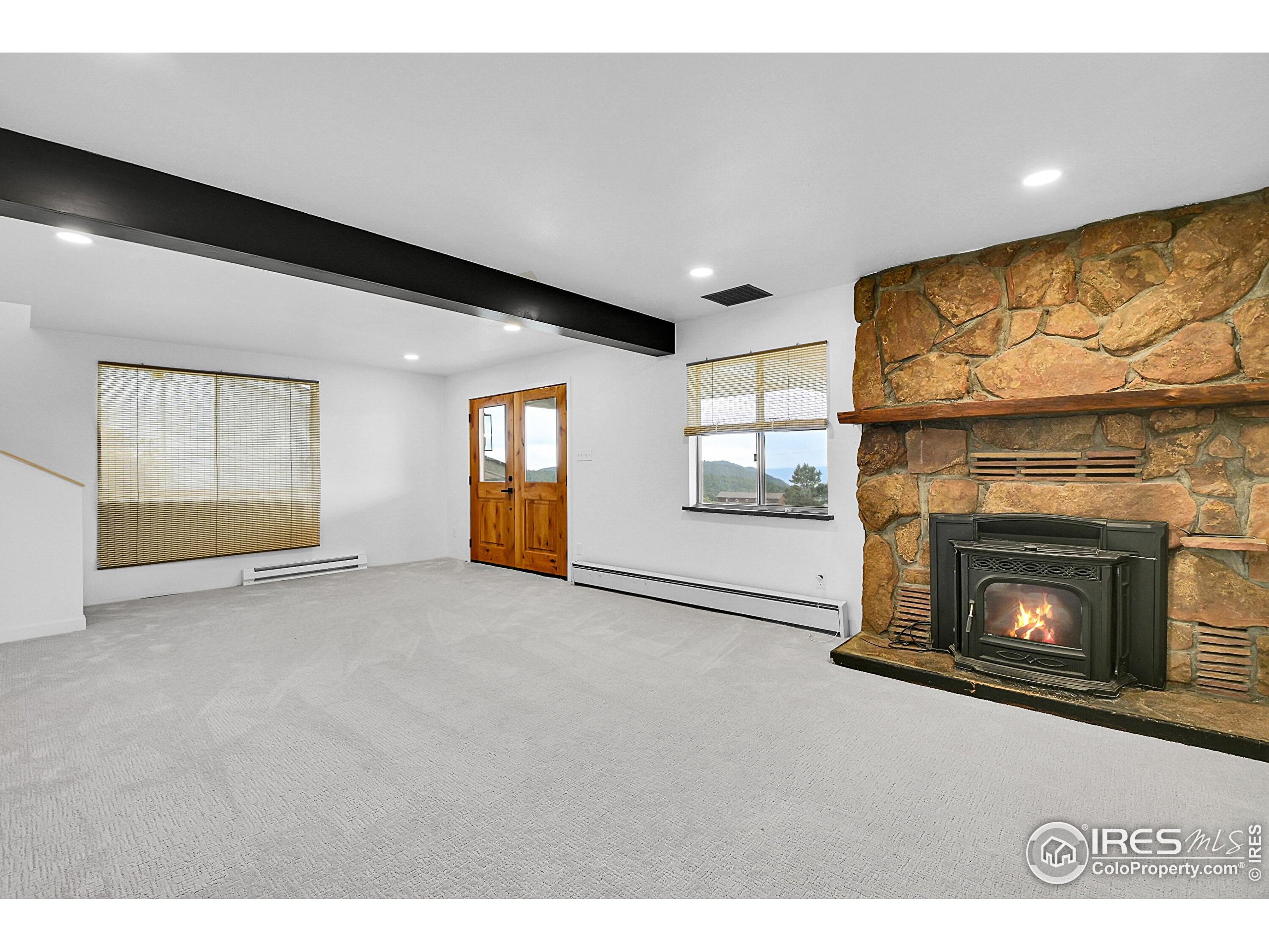 24927 Agate Avenue Conifer, CO 80433 - Photo 21 of 33 a view of empty room with a fireplace