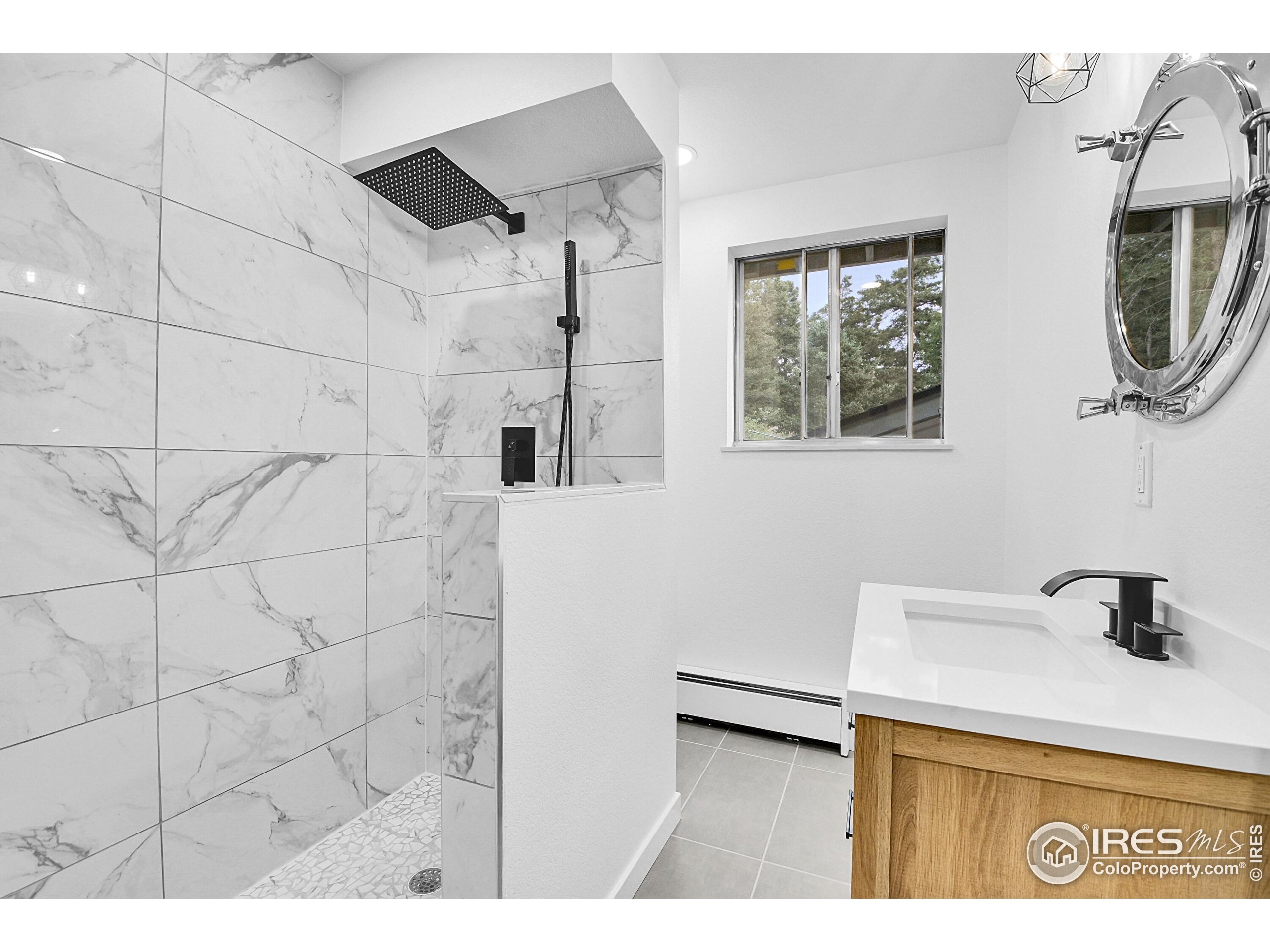 24927 Agate Avenue Conifer, CO 80433 - Photo 23 of 33 a bathroom with a sink and a mirror