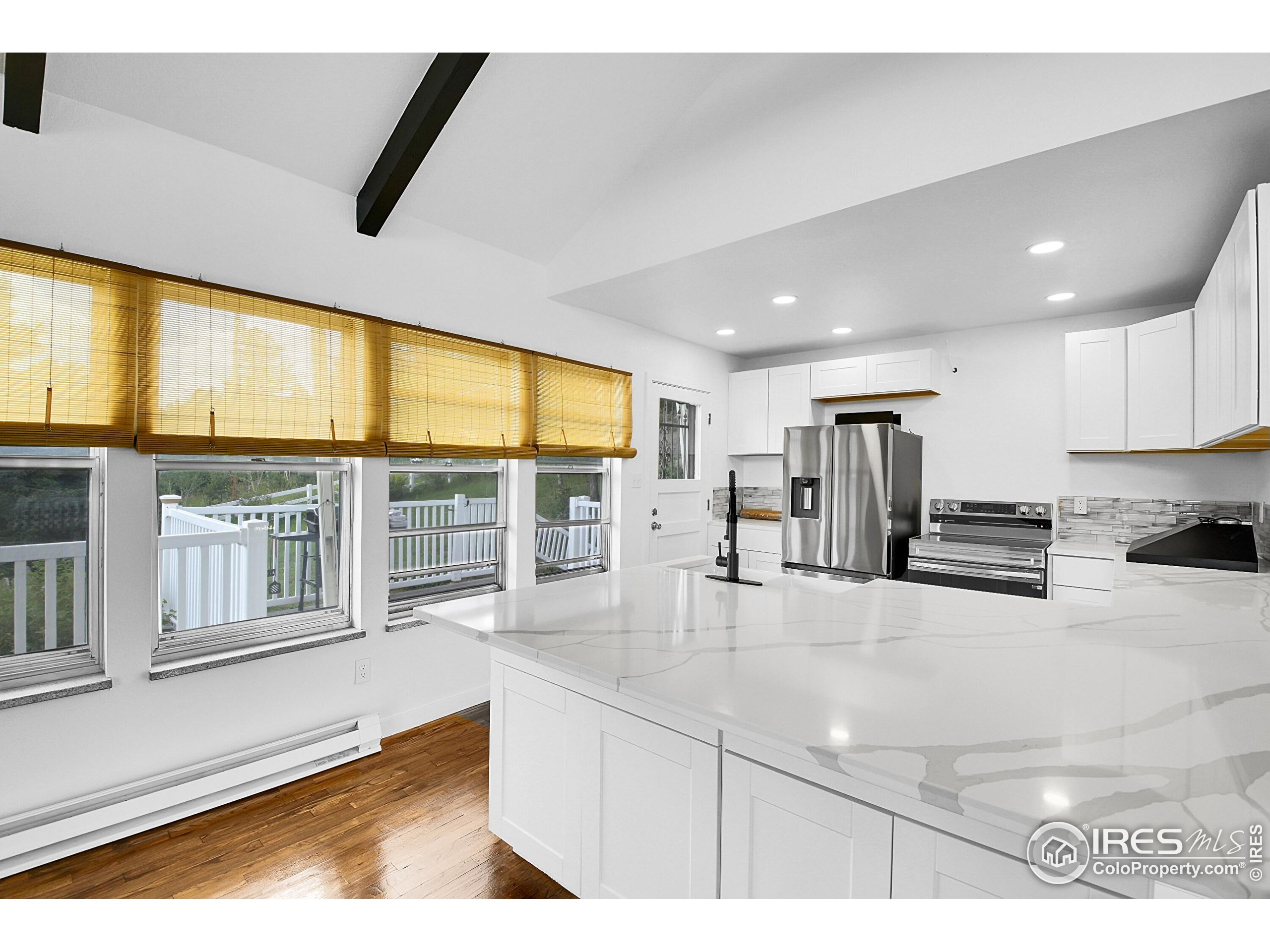 24927 Agate Avenue Conifer, CO 80433 - Photo 29 of 33 a kitchen with stainless steel appliances granite countertop a sink and a refrigerator