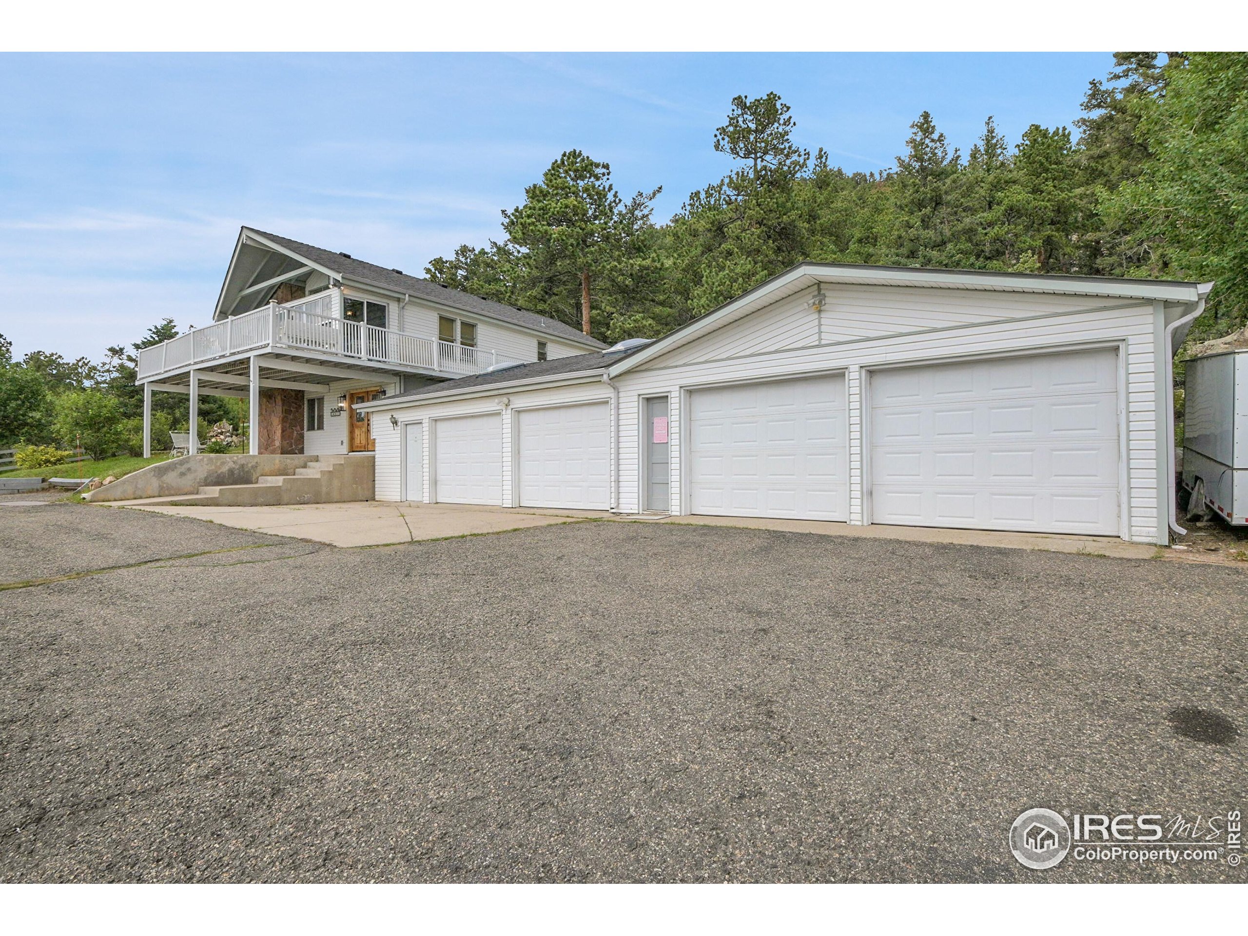 24927 Agate Avenue Conifer, CO 80433 - Photo 3 of 33 a front view of a house with a yard and garage