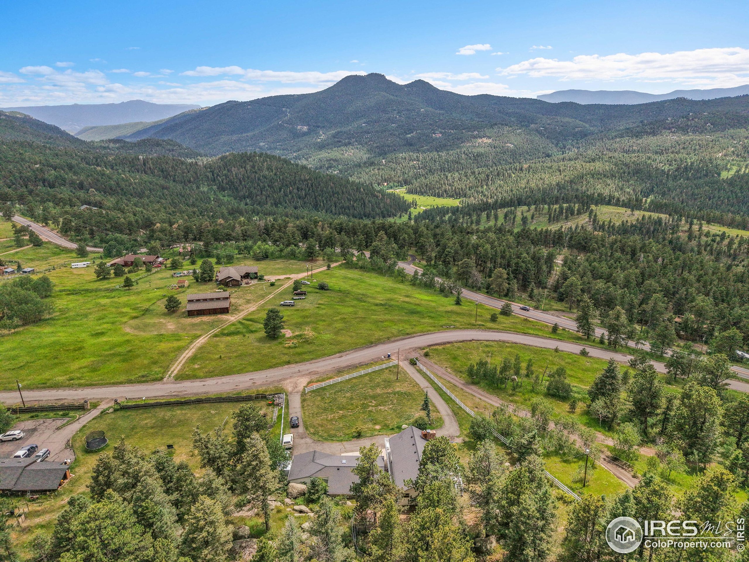 24927 Agate Avenue Conifer, CO 80433 - Photo 7 of 33 a view of a lush green hillside and a houses