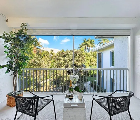 a view of a chairs and table in patio