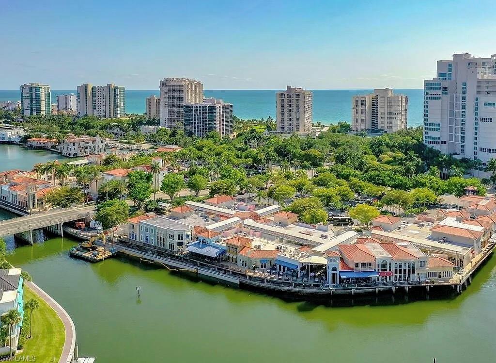 4180 Crayton Road, Unit E8 Naples, FL 34103 - Photo 20 of 20 a aerial view of a house with a garden and lake view