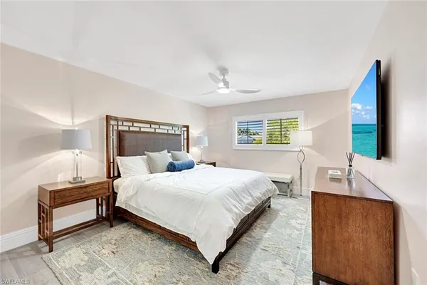 a bedroom with a bed lamp and a dresser