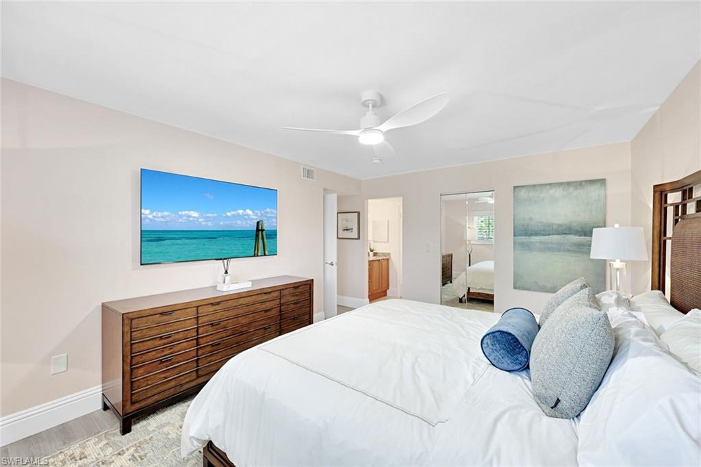 4180 Crayton Road, Unit E8 Naples, FL 34103 - Photo 7 of 20 a bedroom with a bed and a flat screen tv