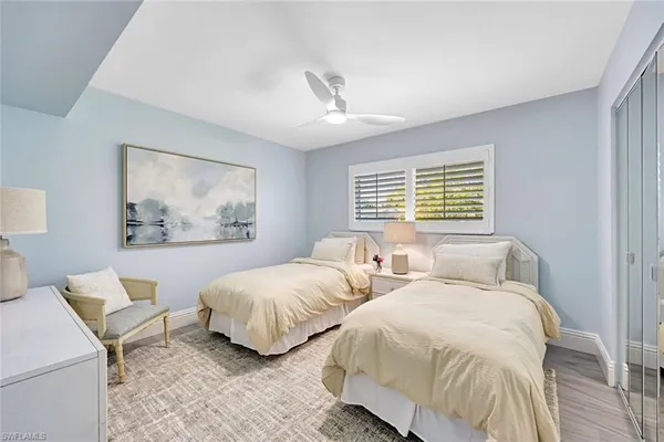 a bedroom with two beds and a window