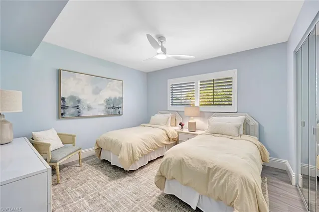 a bedroom with two beds and a window