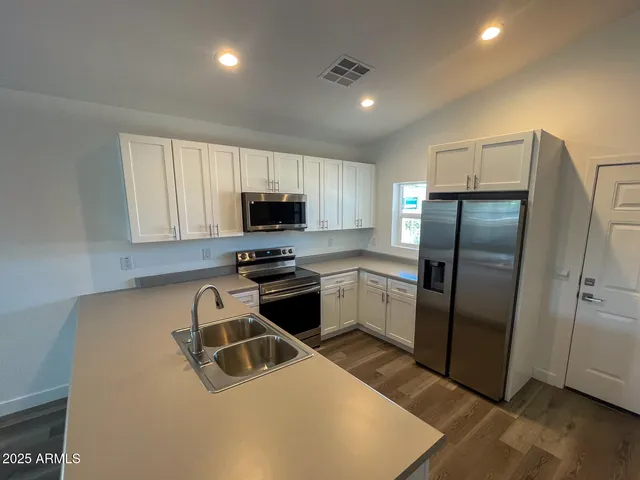 a kitchen with a refrigerator sink and microwave