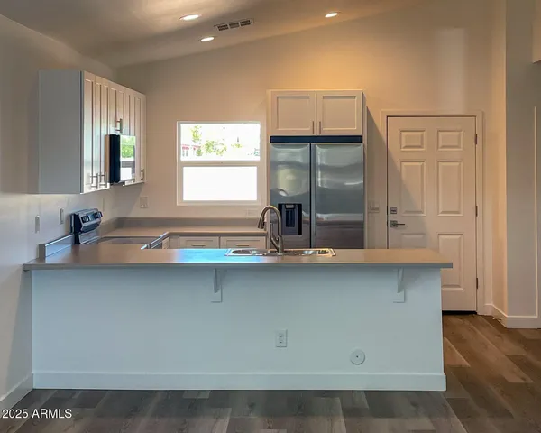 a kitchen with a sink and wooden cabinets
