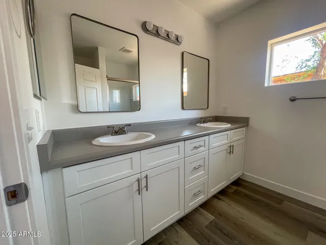 a bathroom with 2 sink and a mirror