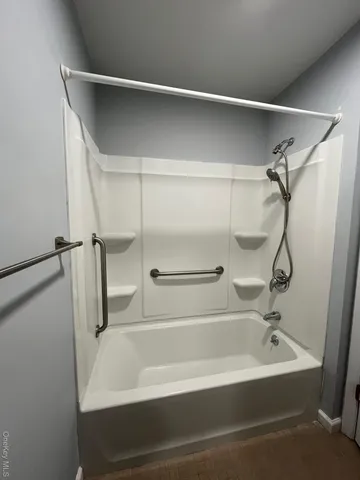 a white bath tub sitting next to a white sink