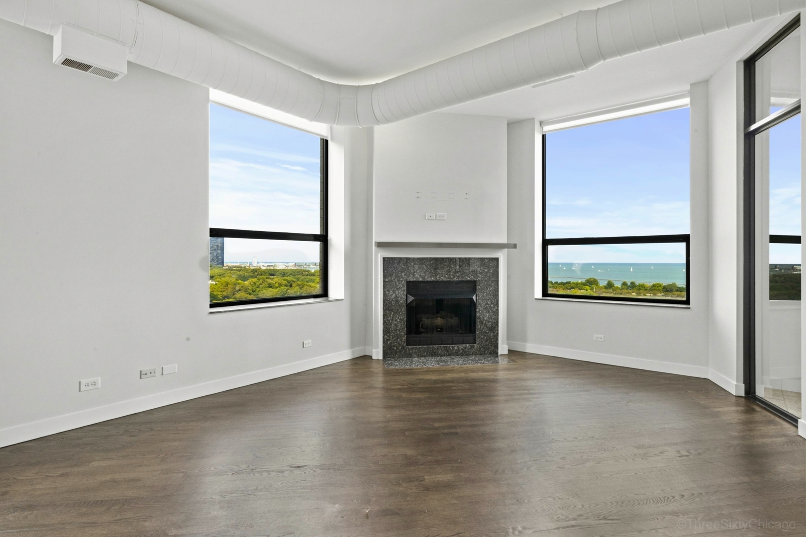 910 South Michigan Avenue, Unit 1004 Chicago, IL 60605 - Photo 12 of 22 a view of an empty room with a window and fireplace