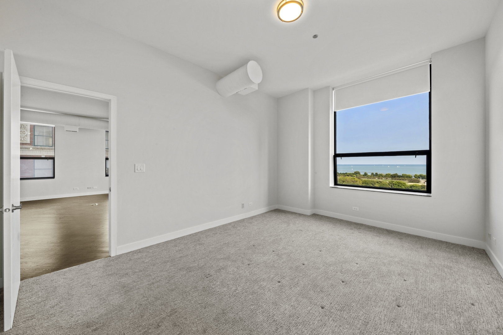 910 South Michigan Avenue, Unit 1004 Chicago, IL 60605 - Photo 13 of 22 a view of an empty room with a window