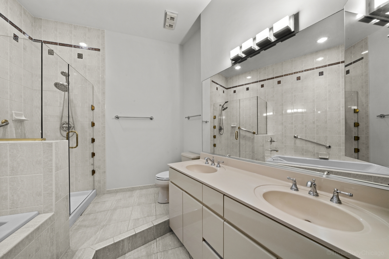 910 South Michigan Avenue, Unit 1004 Chicago, IL 60605 - Photo 15 of 22 a bathroom with a sink double vanity granite tub and shower