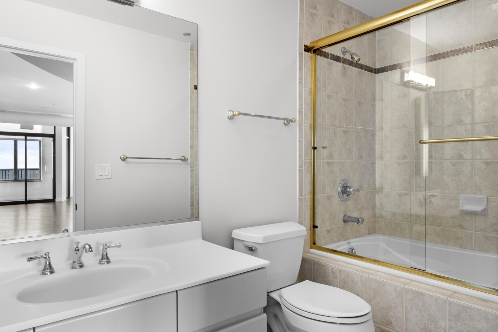 910 South Michigan Avenue, Unit 1004 Chicago, IL 60605 - Photo 17 of 22 a bathroom with a sink toilet and shower