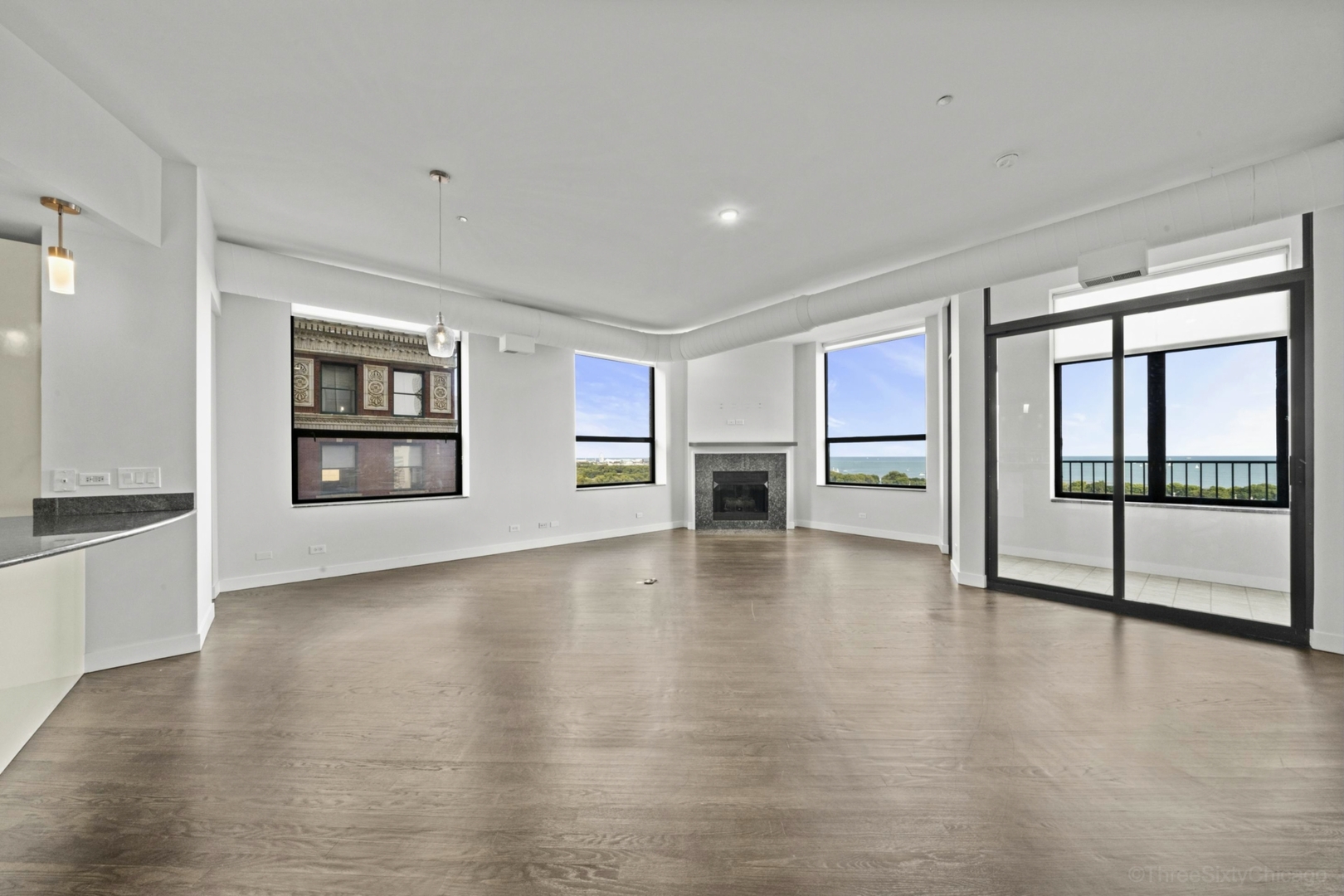 910 South Michigan Avenue, Unit 1004 Chicago, IL 60605 - Photo 2 of 22 a view of an empty room with a window and wooden floor