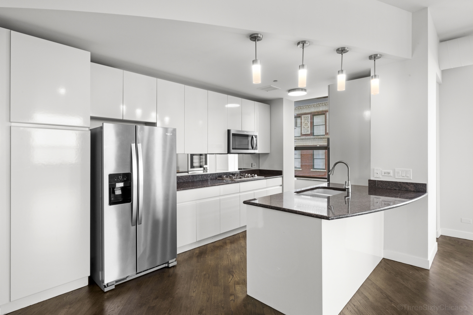910 South Michigan Avenue, Unit 1004 Chicago, IL 60605 - Photo 3 of 22 a kitchen with stainless steel appliances granite countertop a refrigerator a sink and a stove
