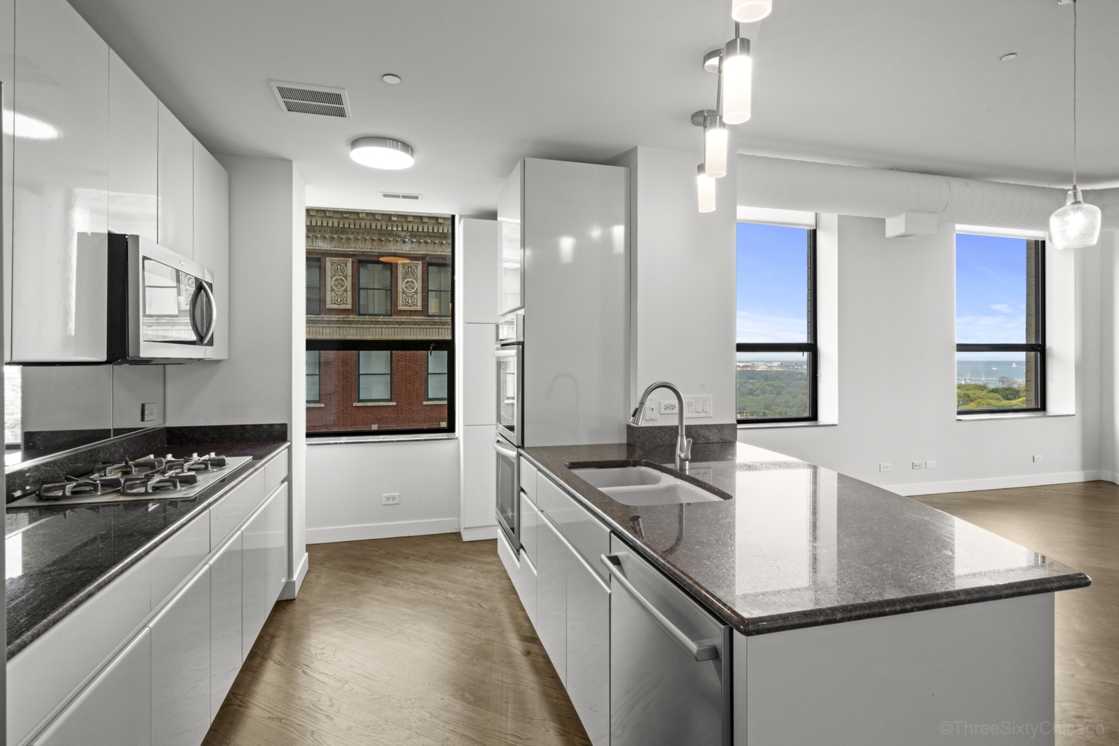910 South Michigan Avenue, Unit 1004 Chicago, IL 60605 - Photo 4 of 22 a kitchen that has a sink and a stove