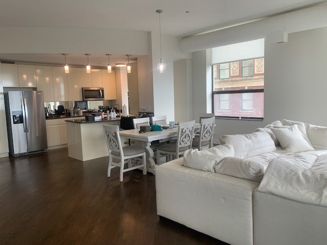 910 South Michigan Avenue, Unit 1004 Chicago, IL 60605 - Photo 8 of 22 a living room with furniture and a wooden floor