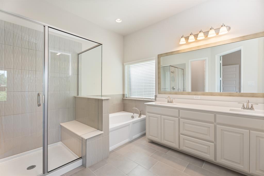 2510 Rockbrook Road Garland, TX 75041 - Photo 18 of 33 a spacious bathroom with a double vanity sink a mirror and a bathtub