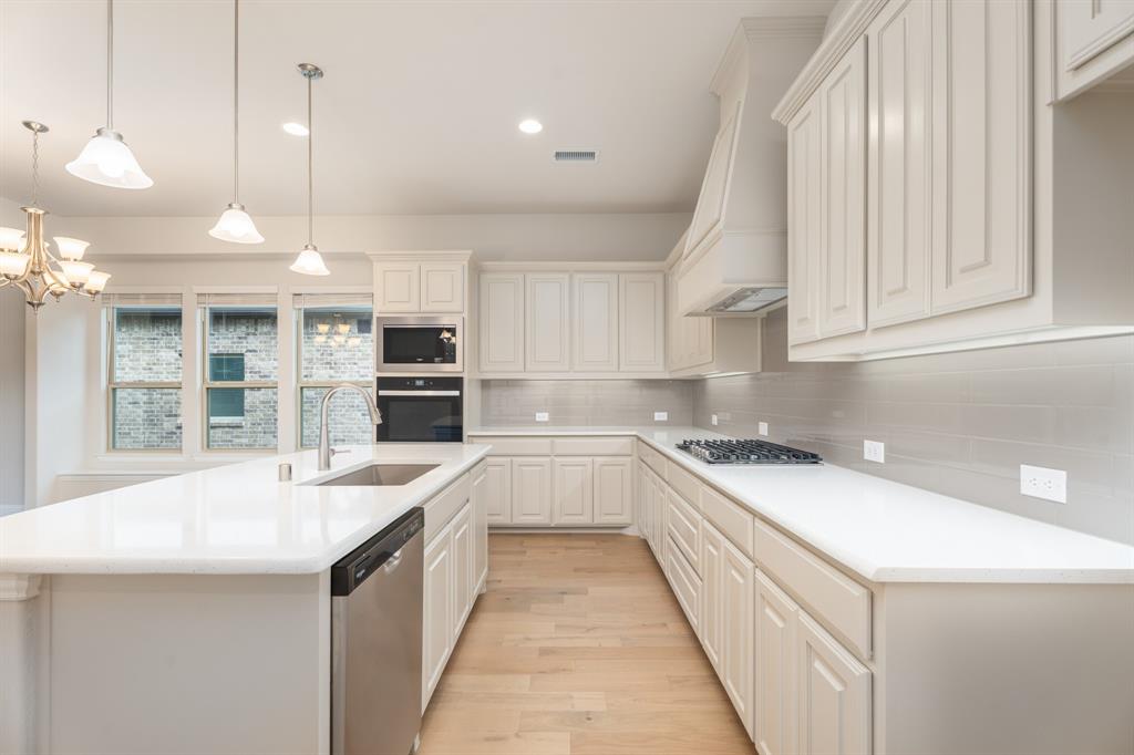 2510 Rockbrook Road Garland, TX 75041 - Photo 23 of 33 a kitchen with stainless steel appliances granite countertop a sink and cabinets