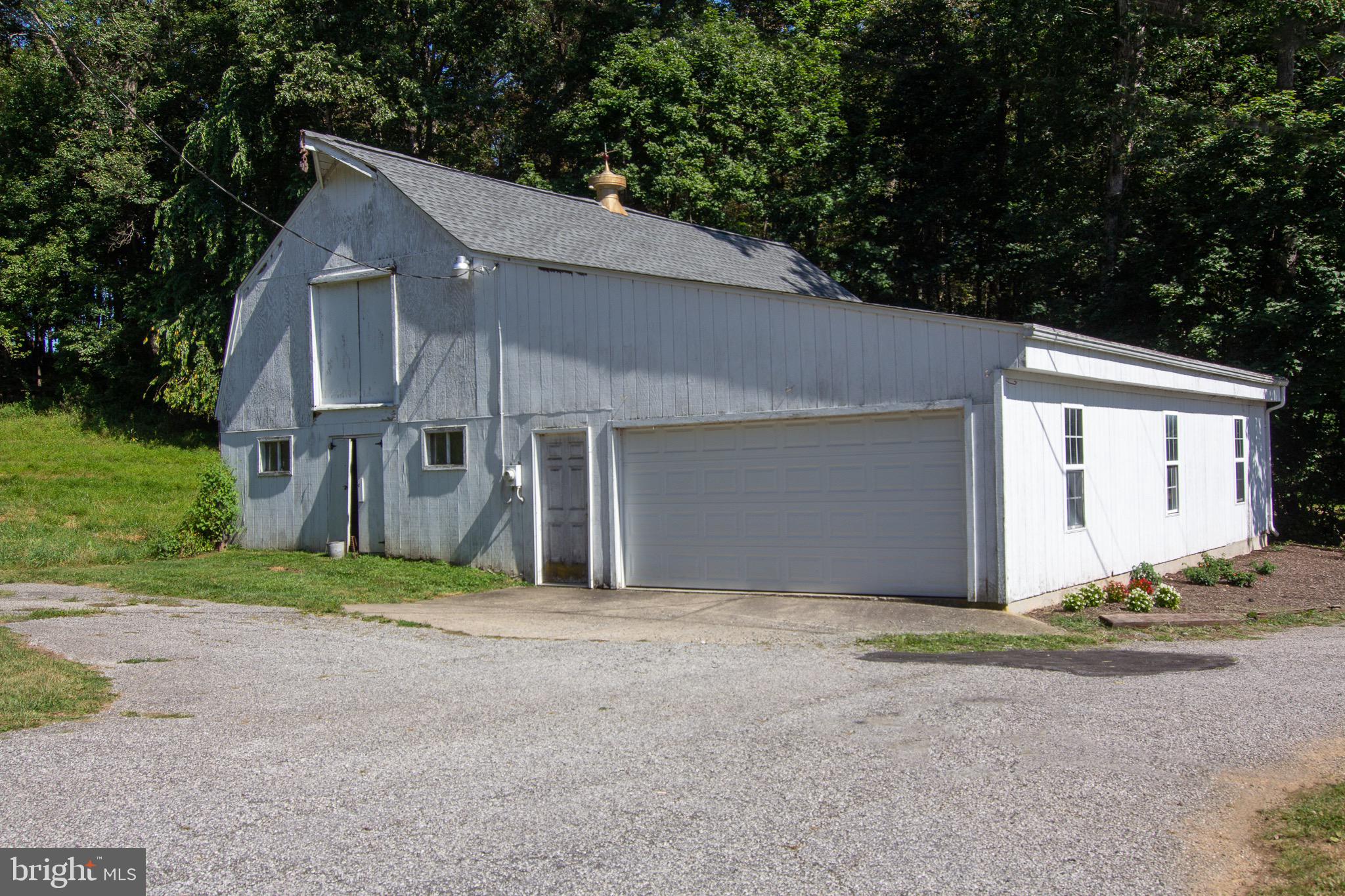 18626 Gunpowder Road Hampstead, MD 21074 - Photo 11 of 66 a house with lots of trees in the background