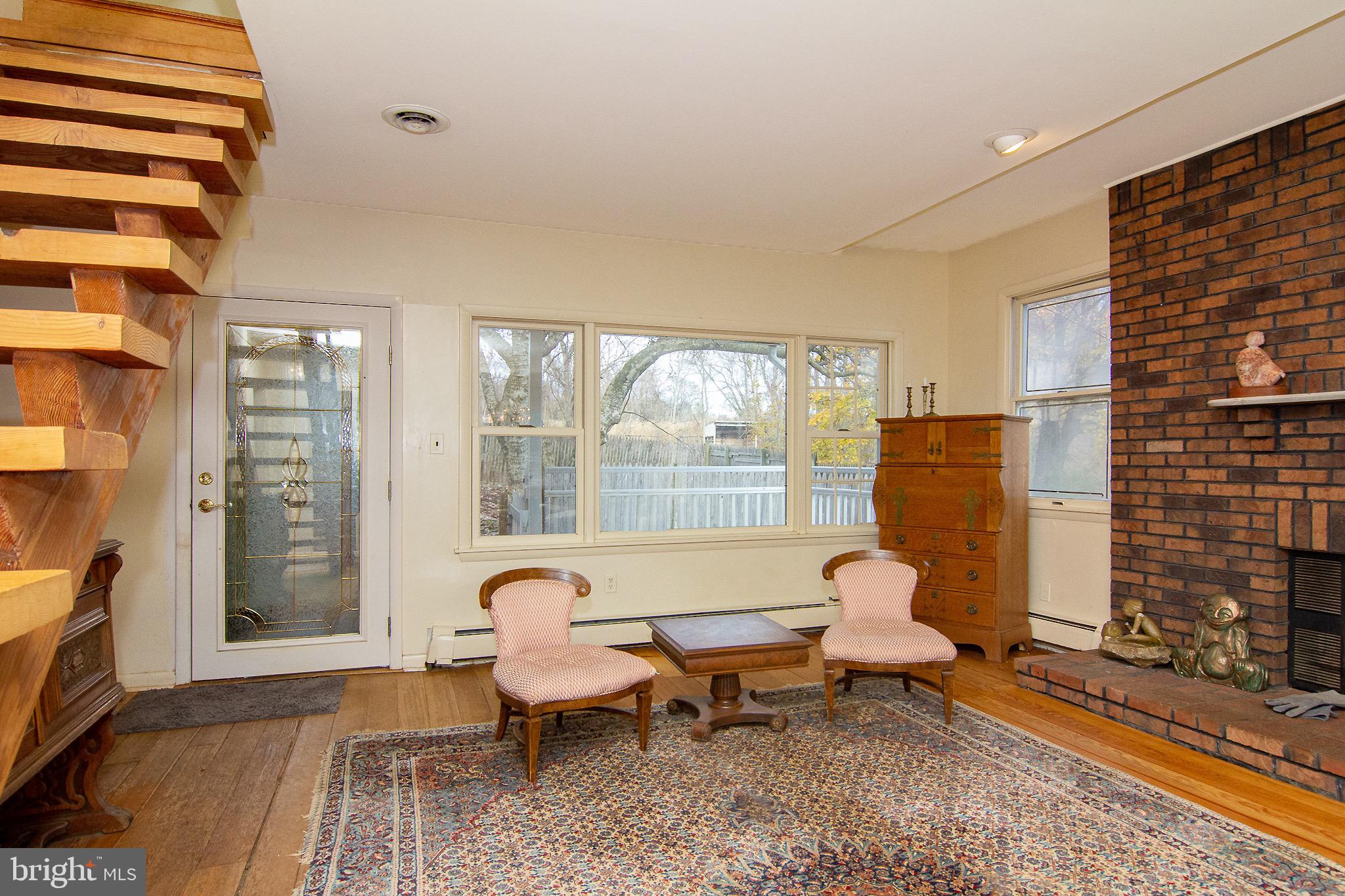 18626 Gunpowder Road Hampstead, MD 21074 - Photo 25 of 66 a living room with furniture a rug and a floor to ceiling window