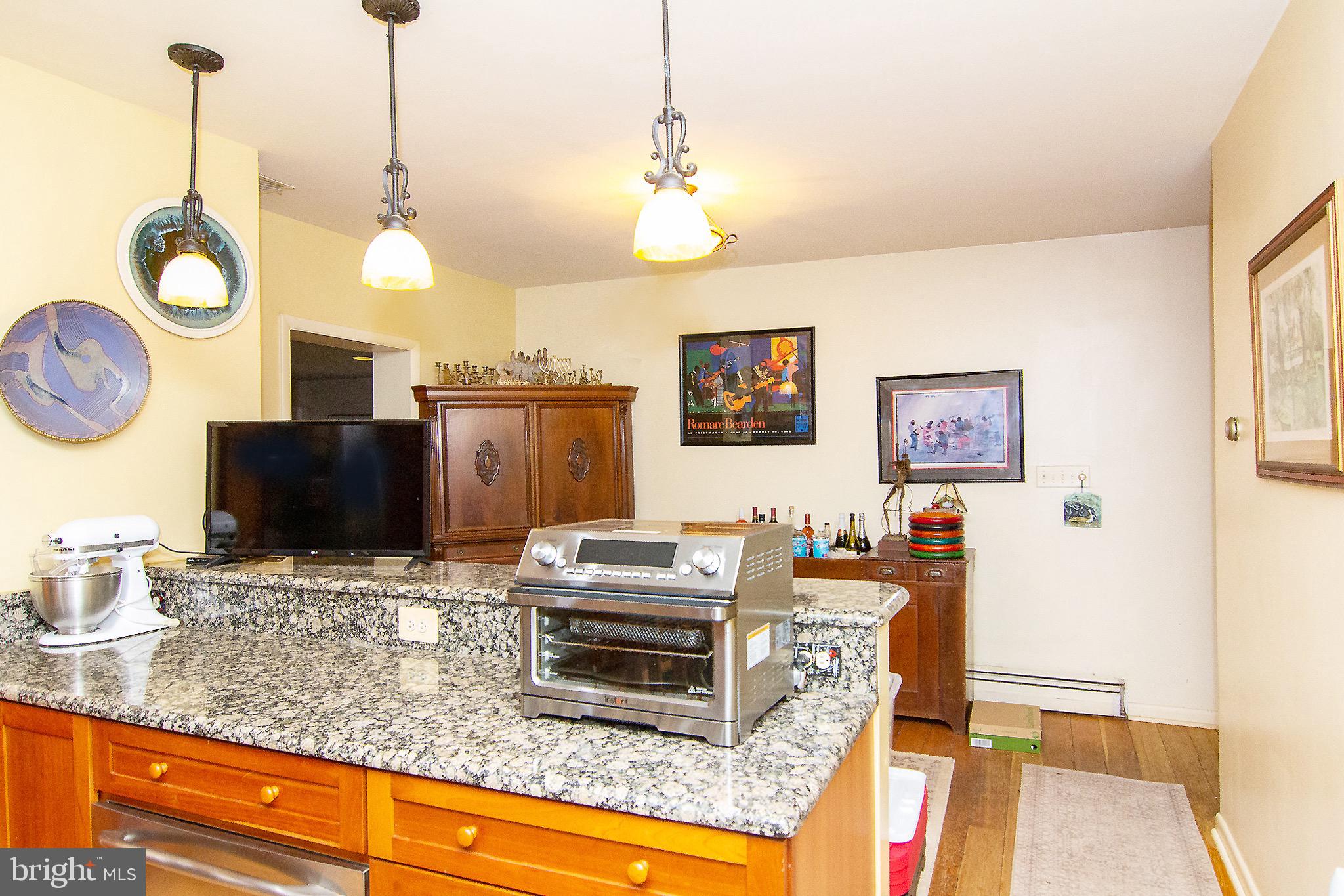 18626 Gunpowder Road Hampstead, MD 21074 - Photo 34 of 66 a living room with furniture a fireplace and a flat screen tv