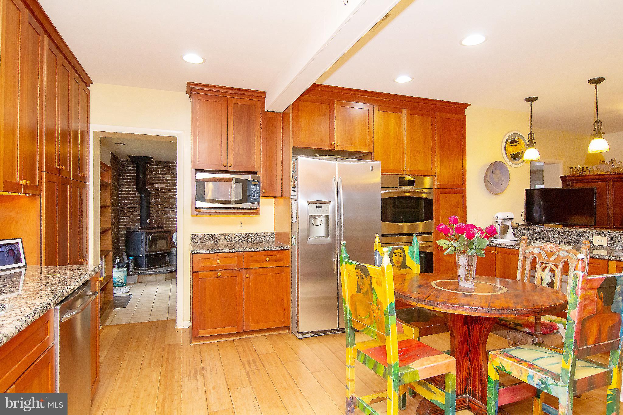 18626 Gunpowder Road Hampstead, MD 21074 - Photo 36 of 66 a kitchen with stainless steel appliances kitchen island granite countertop a refrigerator and microwave