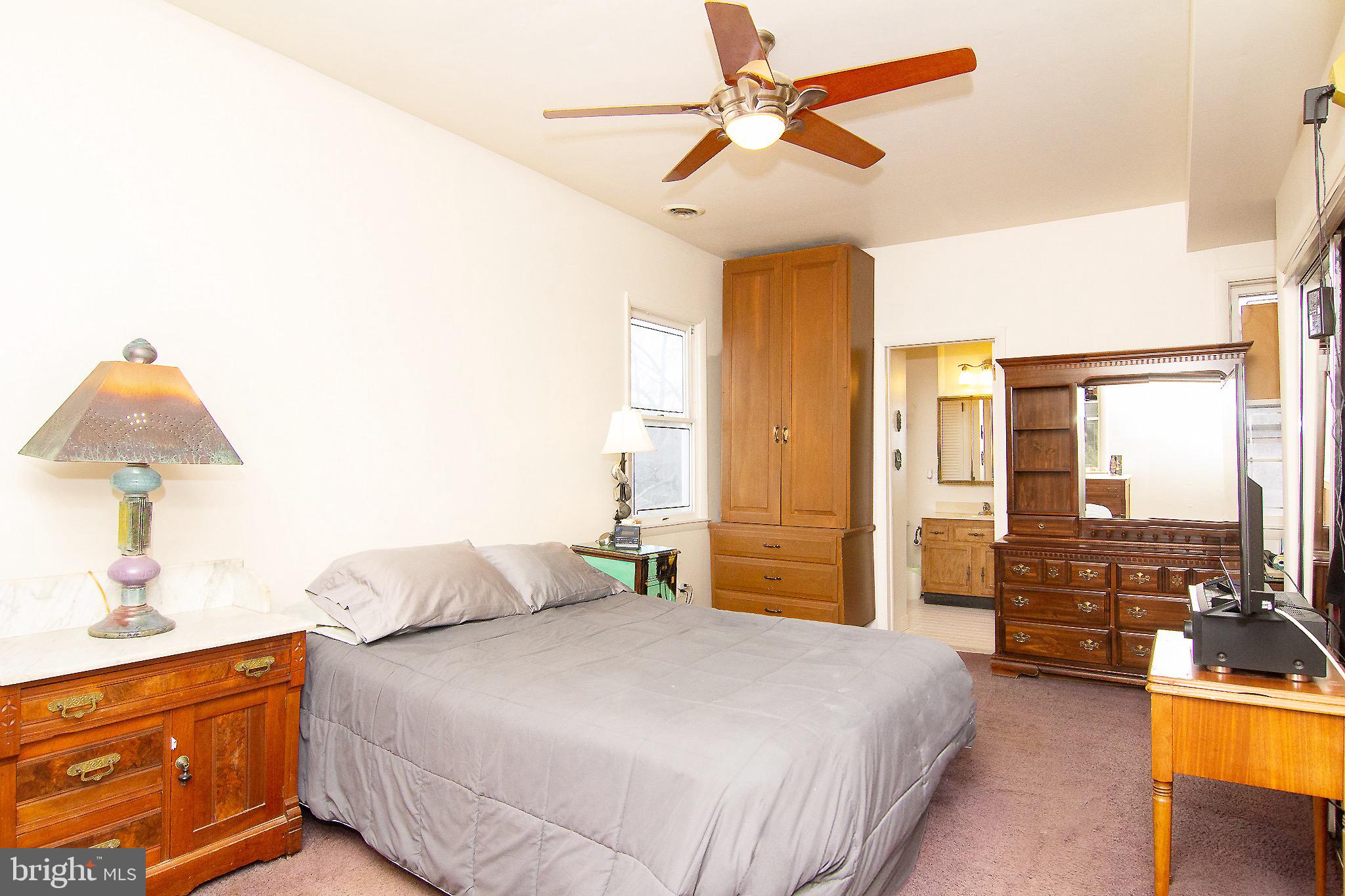 18626 Gunpowder Road Hampstead, MD 21074 - Photo 47 of 66 a bedroom with a bed and a chandelier