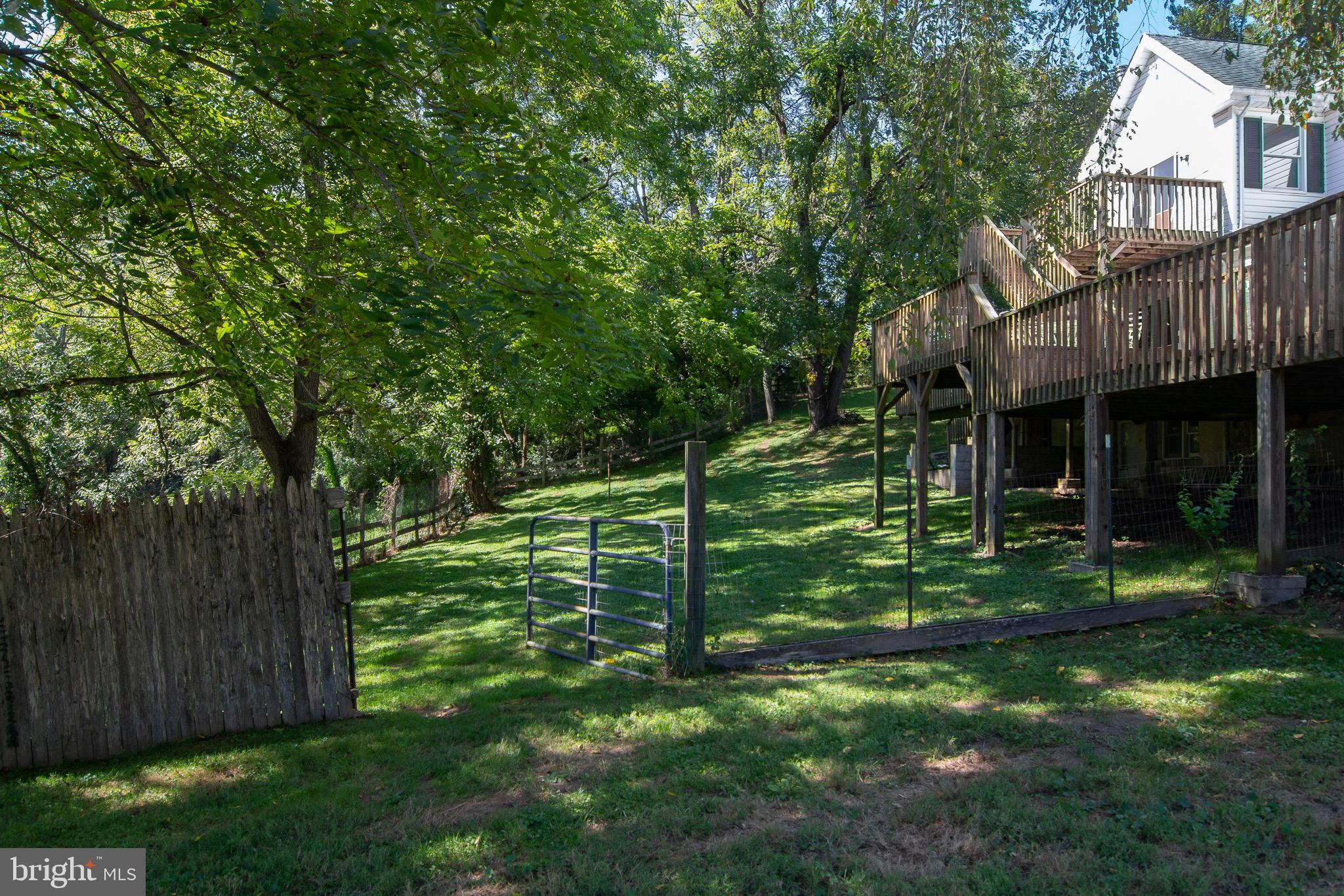 18626 Gunpowder Road Hampstead, MD 21074 - Photo 6 of 66 a view of a chair and table in backyard of the house