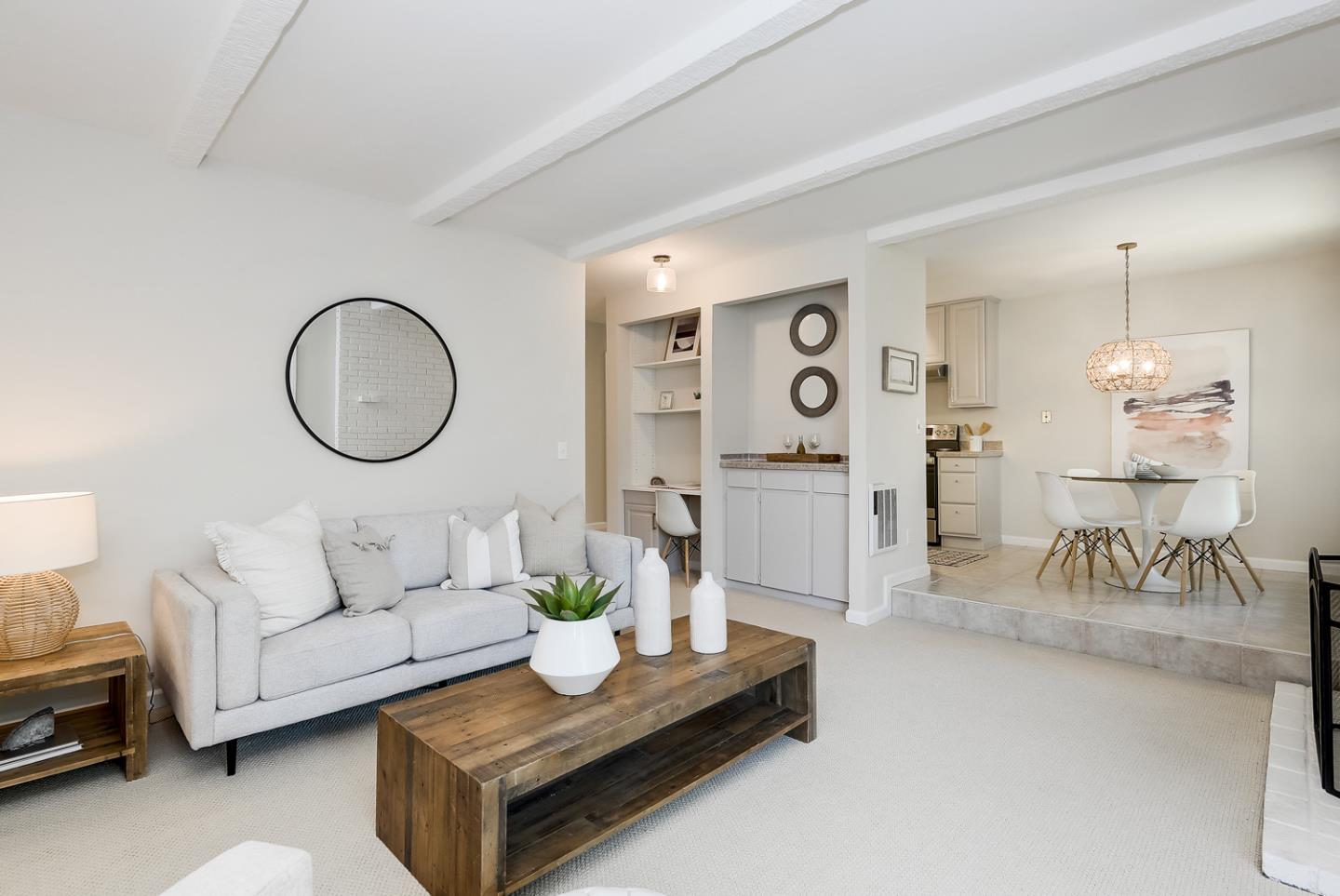 a living room with furniture and a mirror