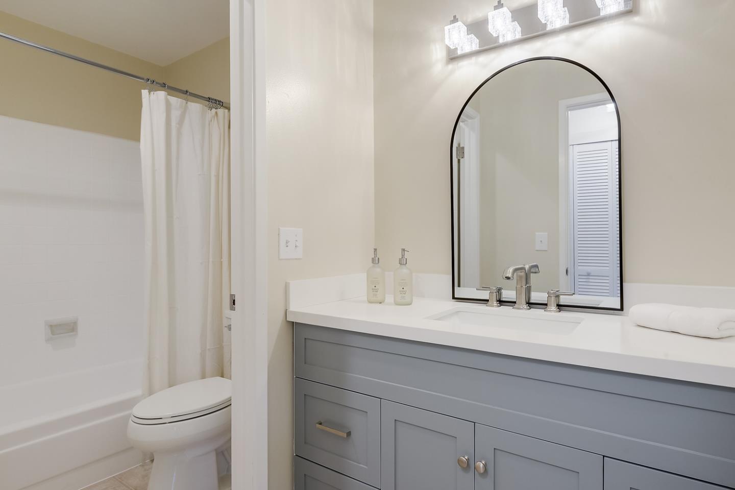 100 East Middlefield Road, Unit 3G Mountain View, CA 94043 - Photo 12 of 22 a bathroom with a granite countertop toilet a sink and a mirror