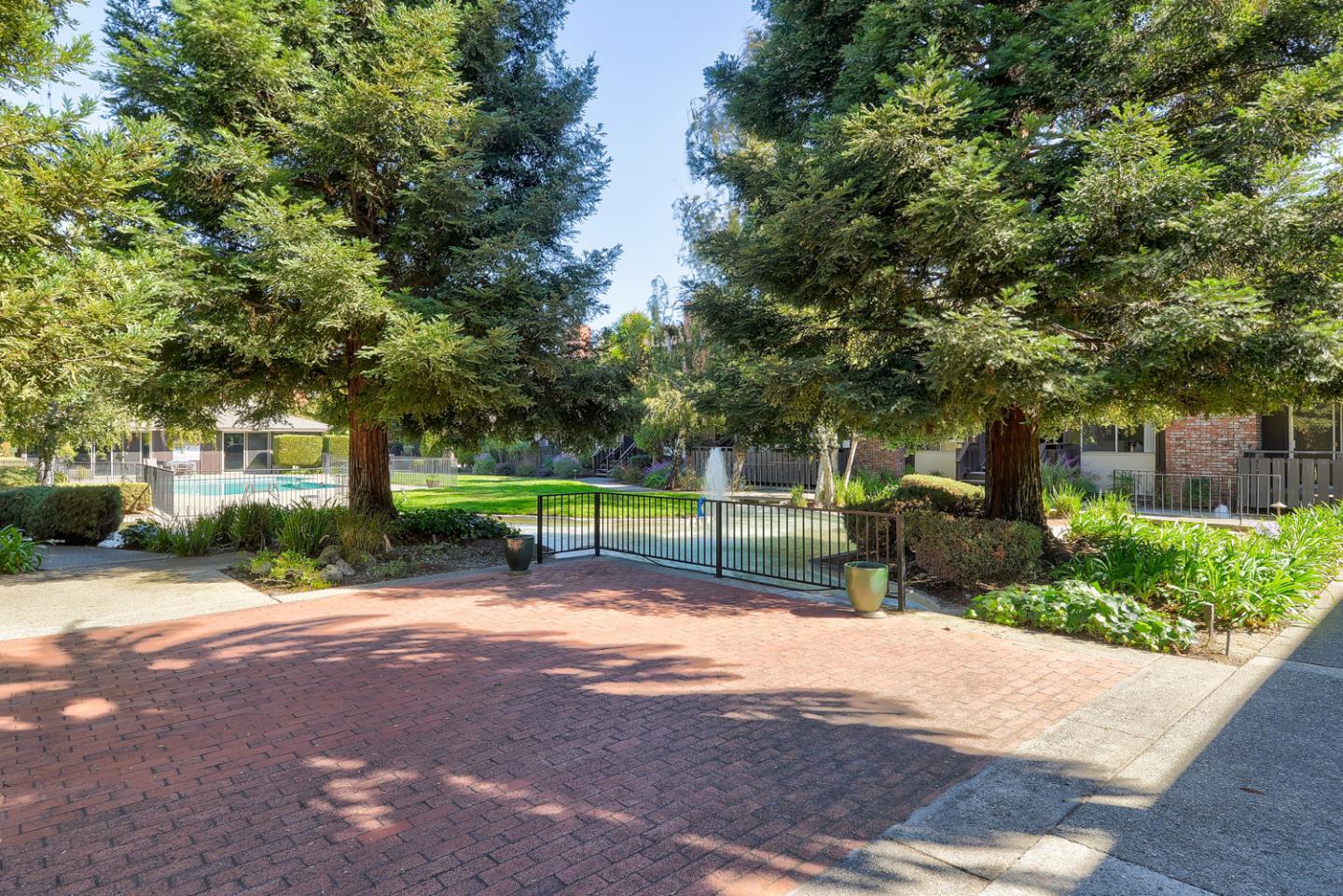 100 East Middlefield Road, Unit 3G Mountain View, CA 94043 - Photo 16 of 22 a view of a park with a bench and trees