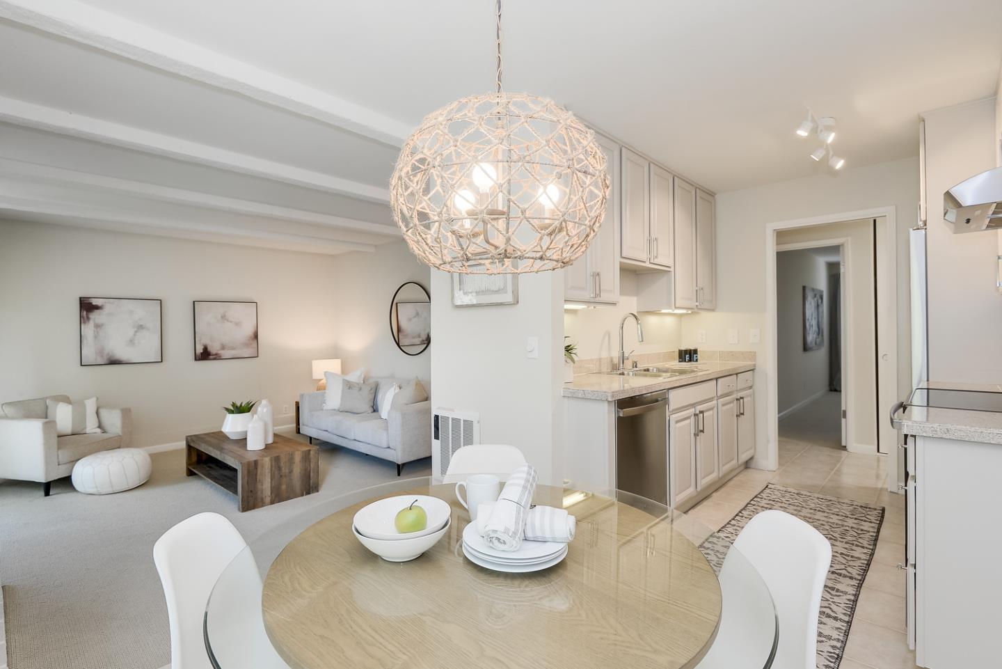100 East Middlefield Road, Unit 3G Mountain View, CA 94043 - Photo 3 of 22 a kitchen with stainless steel appliances granite countertop a dining table chairs and chandelier