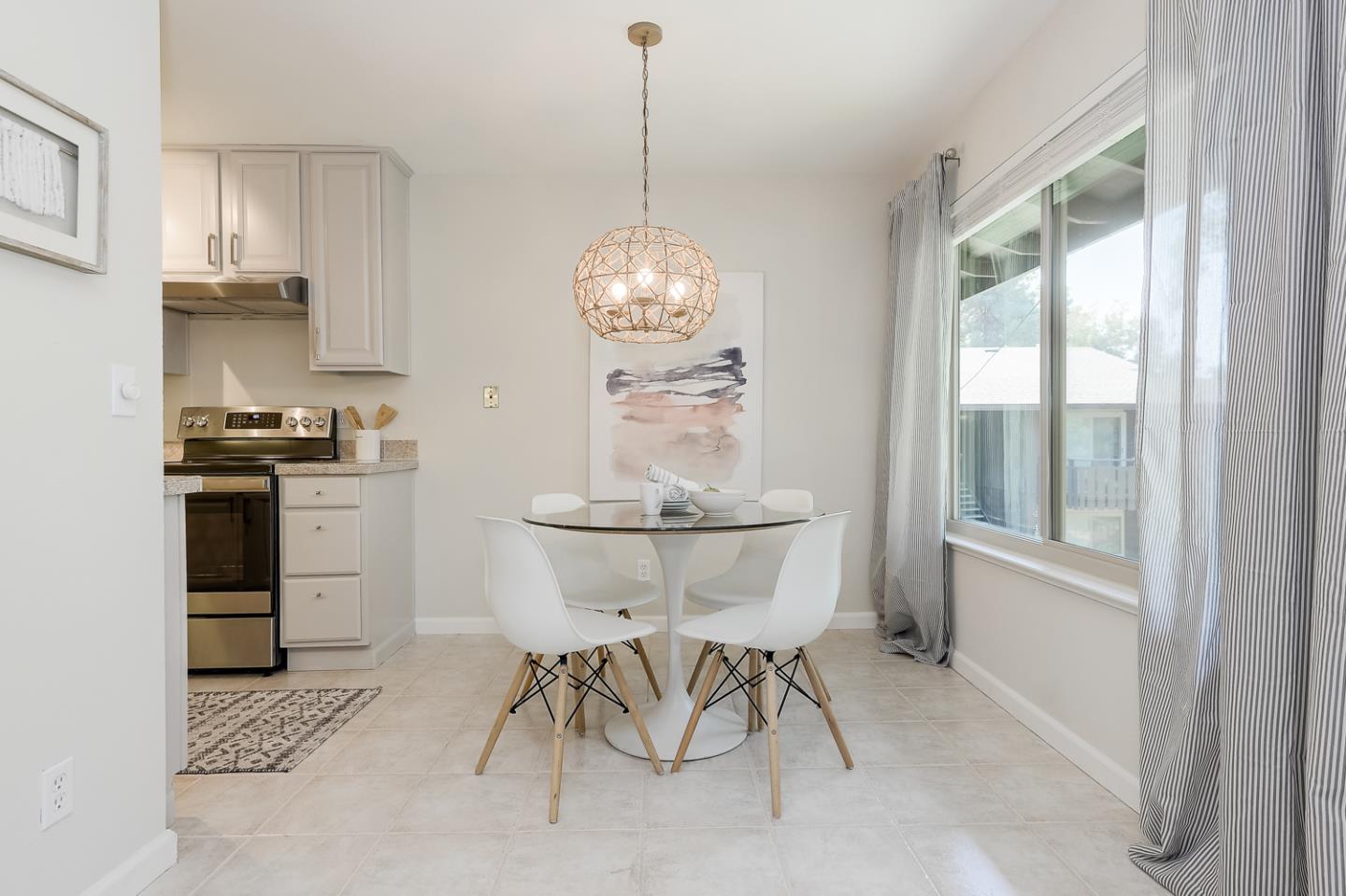 100 East Middlefield Road, Unit 3G Mountain View, CA 94043 - Photo 5 of 22 a kitchen with stainless steel appliances a stove a sink cabinets and a dining table