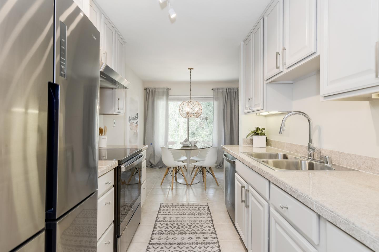 100 East Middlefield Road, Unit 3G Mountain View, CA 94043 - Photo 6 of 22 a kitchen with sink refrigerator and large window