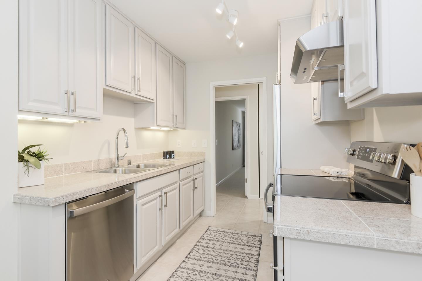 100 East Middlefield Road, Unit 3G Mountain View, CA 94043 - Photo 7 of 22 a kitchen with stainless steel appliances granite countertop a sink stove and refrigerator
