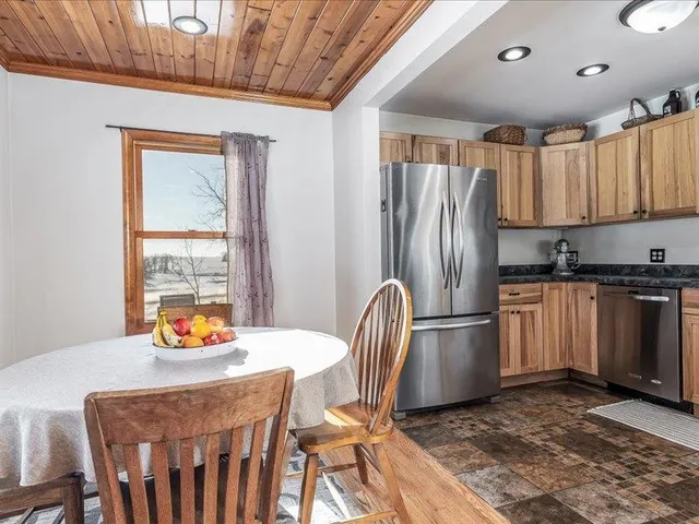 a kitchen with stainless steel appliances granite countertop a refrigerator a sink a stove and island